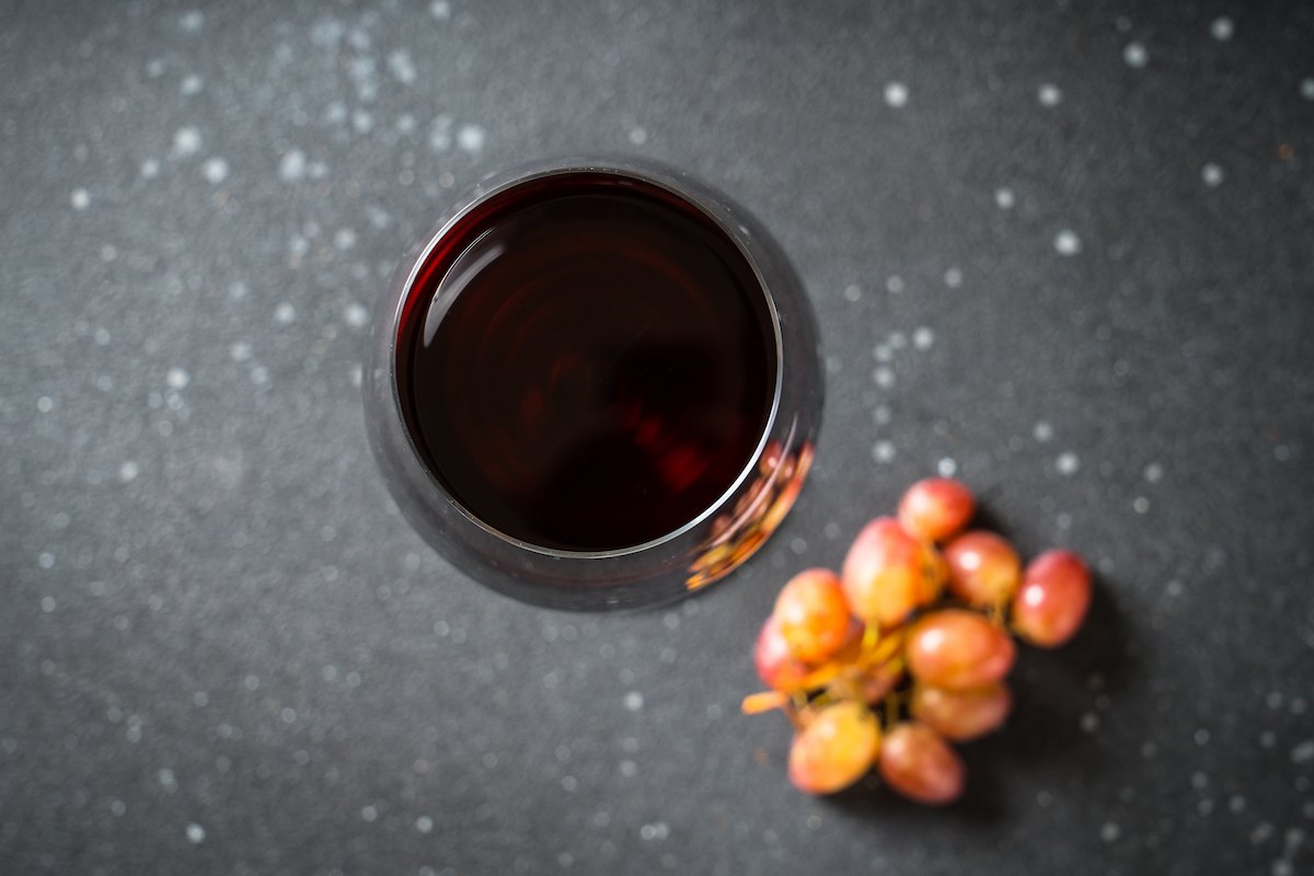 glass-of-wine-bottle-and-fresh-crape-on-black-2025-08-03-20-13-02-utc (1).jpg