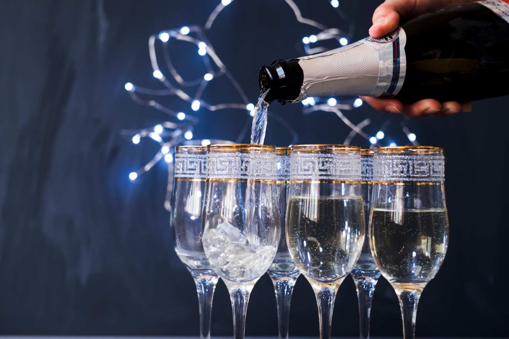 human-hand-pouring-champagne-into-transparent-glass-party (1).jpg