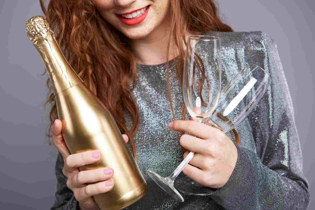 young-woman-holding-champagne-flute-bottle (1).jpg